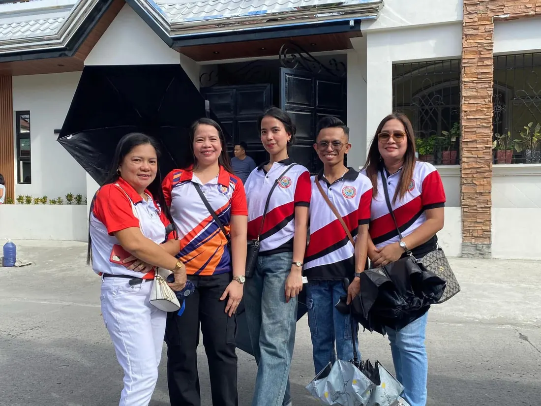 School staff wearing matching red, white and black poloshirts